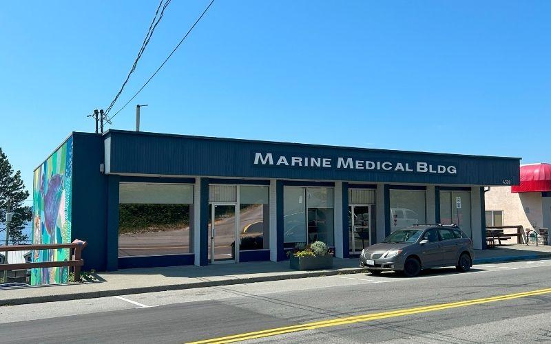 Building with 'Marine Medical Bldg' sign on a clear day
